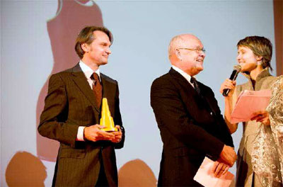Hans-Jürgen Hübner (CEO do Grupo Schoeller), Hans U. Kohn (COO da Schoeller Technologies) e Nicole Salathé (apresentadora do prêmio)